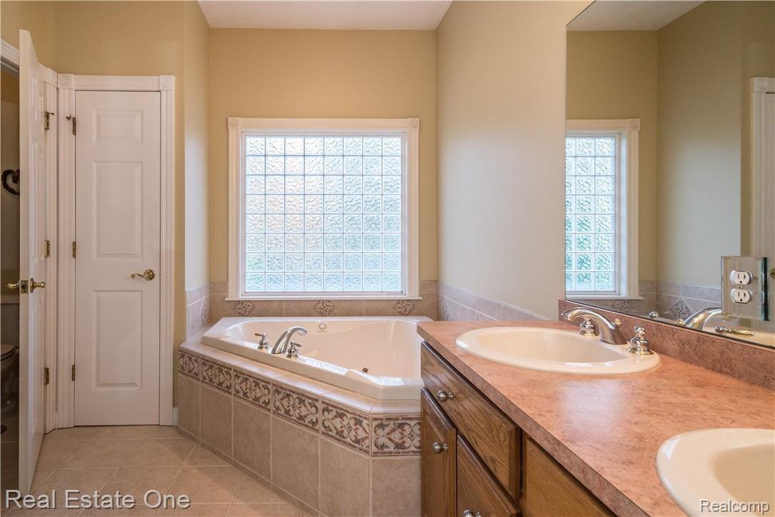 4159 Sundance Meadows Howell, MI 48843 - Photo 26 of 50 Beautiful tile work, double sinks