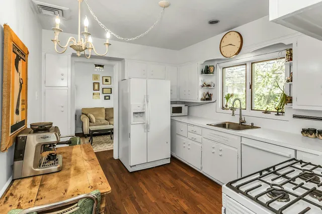 a kitchen with wooden cabinets and window