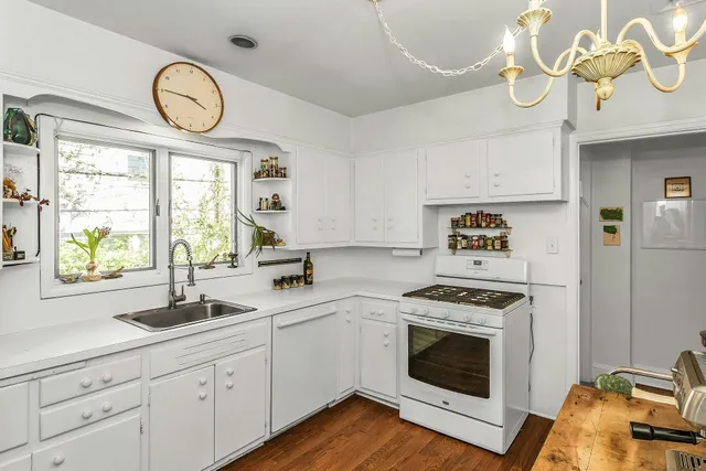 a kitchen with cabinets a window and stainless steel appliances