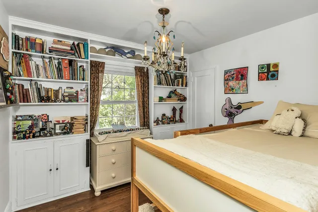 a bed room with a bed and a book shelf