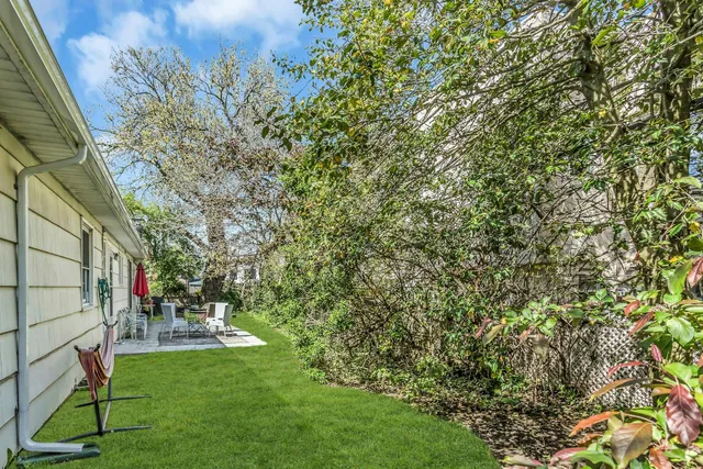 a backyard of a house with table and chairs
