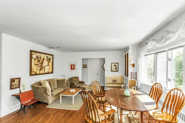a work room with furniture and large windows
