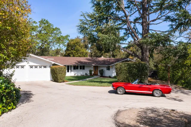 a view of a cars parked in front of a house