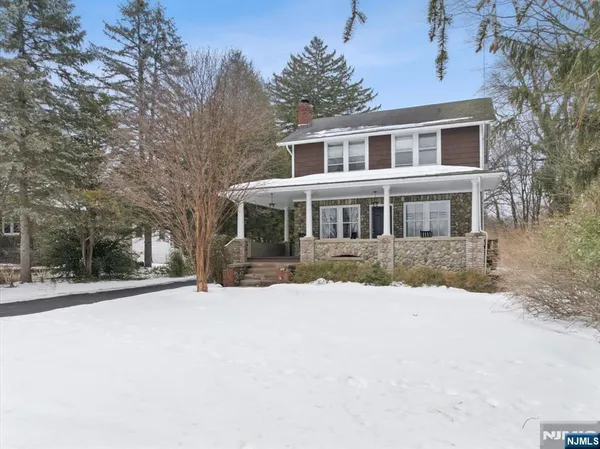 a view of a house with a yard covered in snow