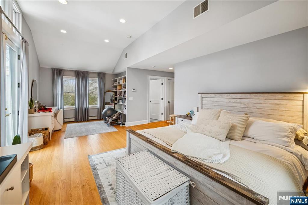138 Chestnut Ridge Road Saddle River, NJ 07458 - Photo 13 of 31 a bedroom with a bed and wooden floor