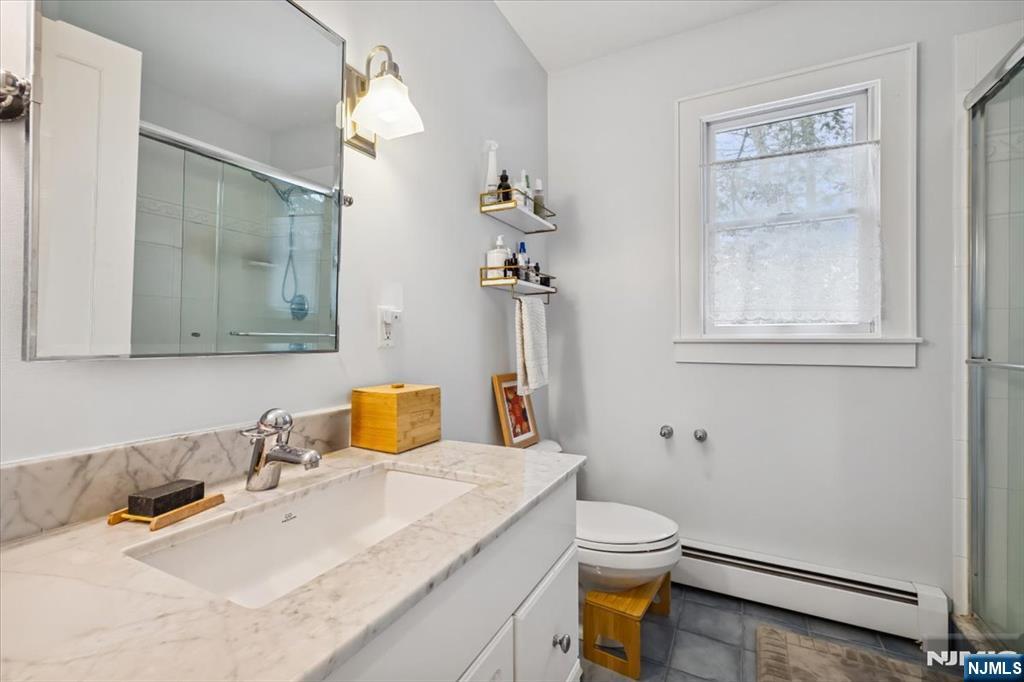 138 Chestnut Ridge Road Saddle River, NJ 07458 - Photo 14 of 31 a bathroom with a granite countertop sink mirror vanity and toilet