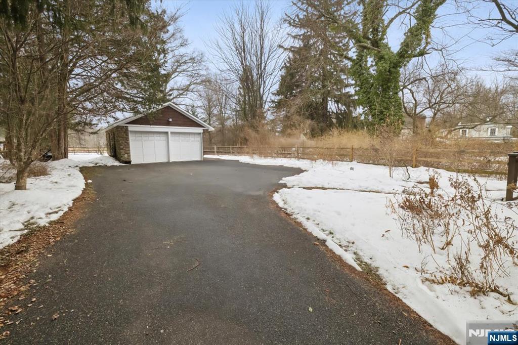 138 Chestnut Ridge Road Saddle River, NJ 07458 - Photo 20 of 31 a view of a house with a yard covered in snow
