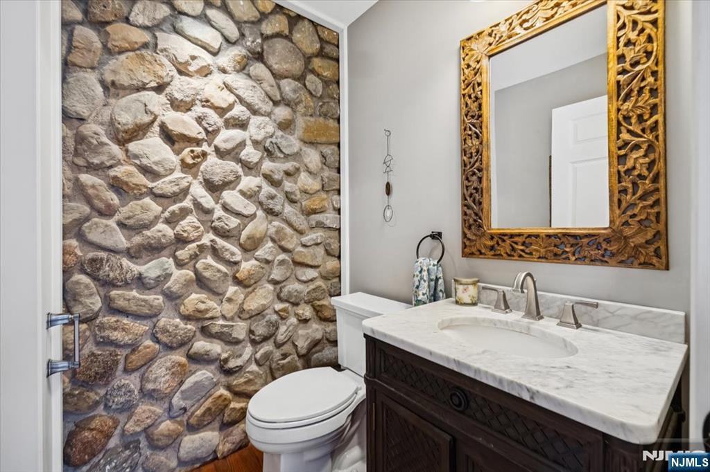 138 Chestnut Ridge Road Saddle River, NJ 07458 - Photo 4 of 31 a bathroom with a granite countertop sink and a toilet