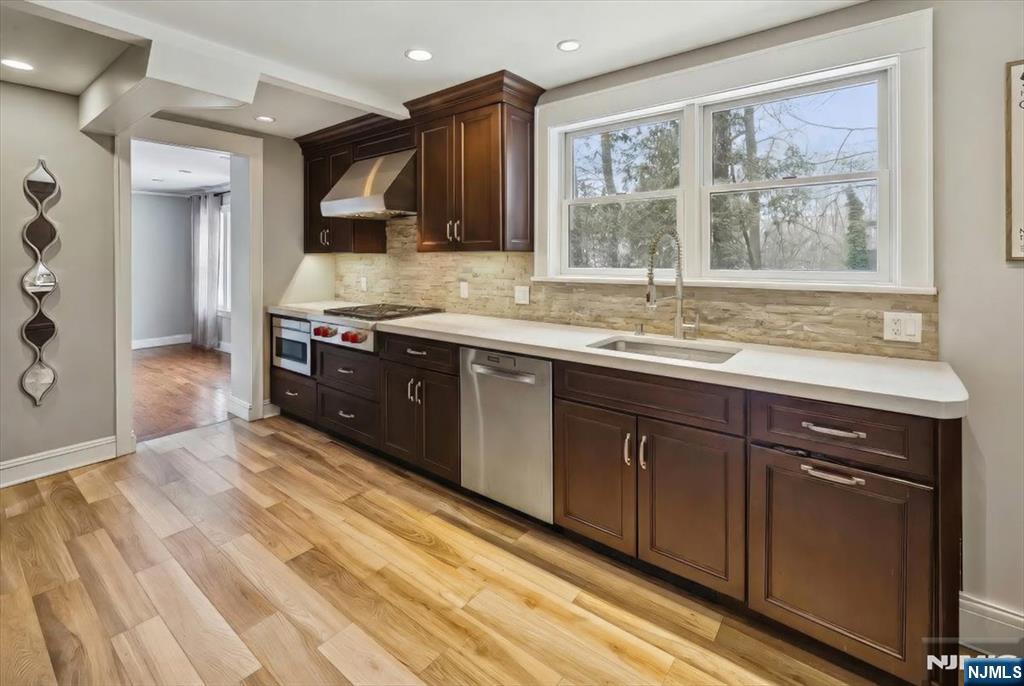 138 Chestnut Ridge Road Saddle River, NJ 07458 - Photo 7 of 31 a kitchen with stainless steel appliances granite countertop a sink stove and cabinets