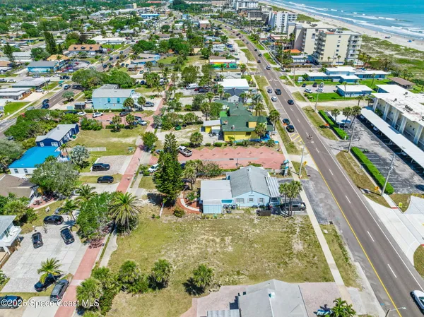 an aerial view of residential houses with outdoor space