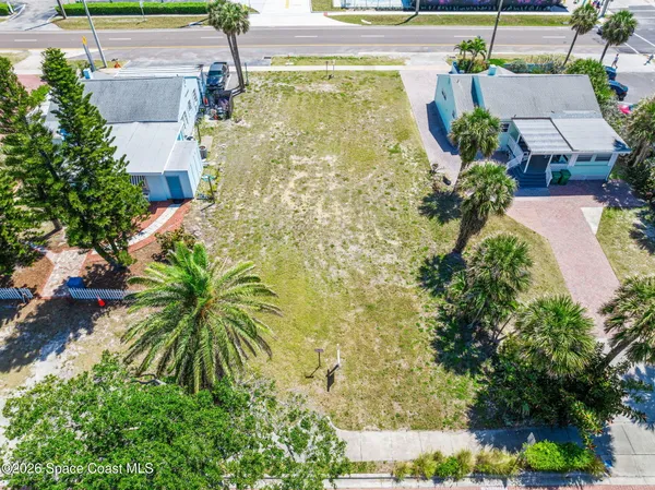 an aerial view of a house with pool and garden