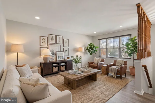 a living room with furniture large window and a table