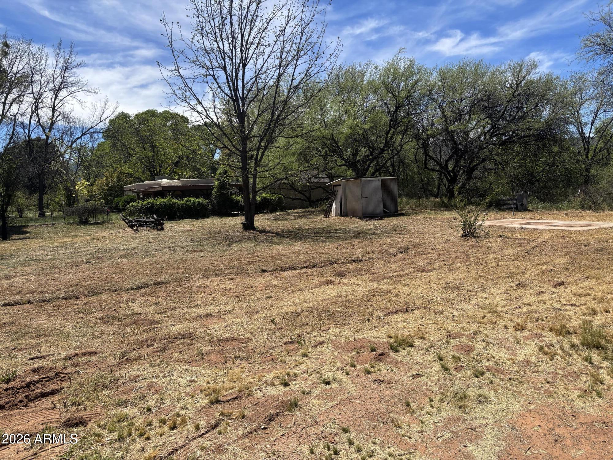 2118 North Rustler Trail, Unit 58 Camp Verde, AZ 86322 - Photo 12 of 13 a backyard of a house with large trees and outdoor space