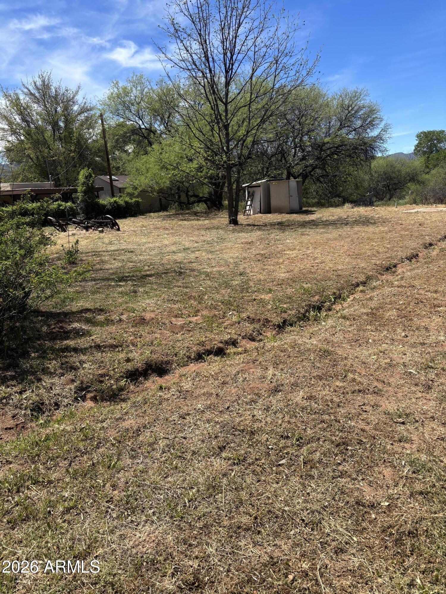 2118 North Rustler Trail, Unit 58 Camp Verde, AZ 86322 - Photo 7 of 13 a backyard of a house with large trees