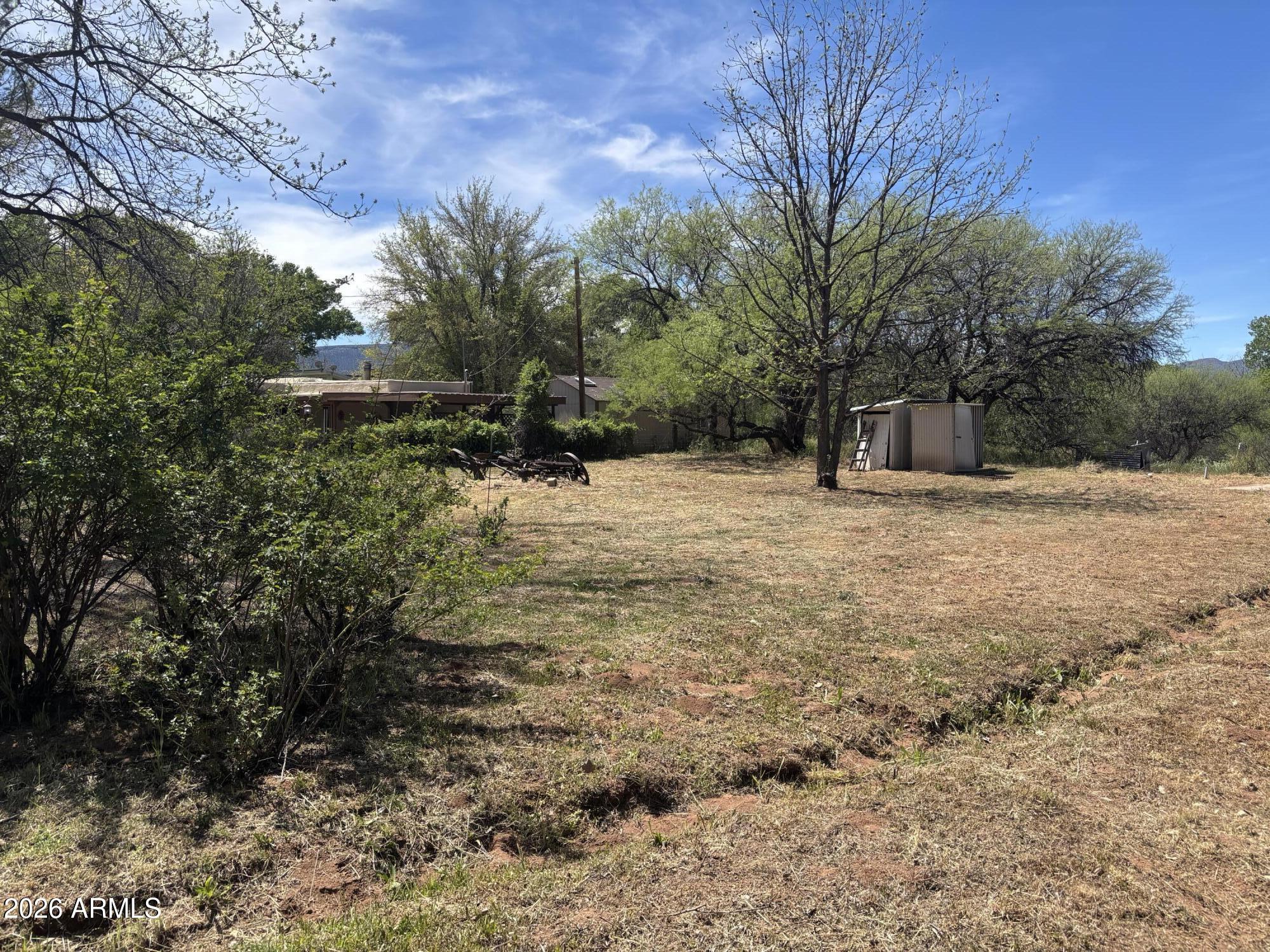 2118 North Rustler Trail, Unit 58 Camp Verde, AZ 86322 - Photo 10 of 13 a tall house with trees in front of it