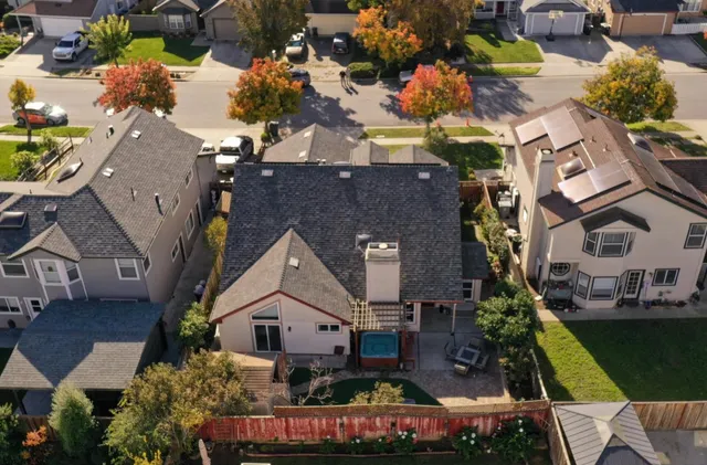 an aerial view of multiple houses with a yard