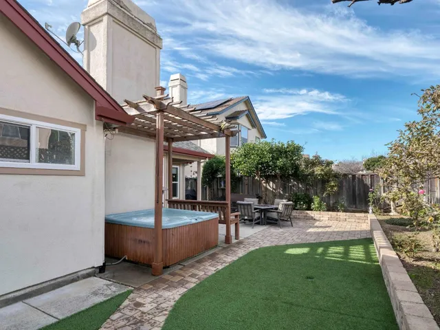 a view of a patio with couches and table and chairs with plants