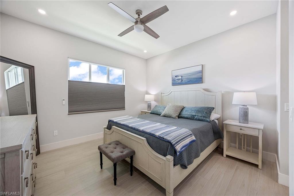 1395 Curlew Avenue, Unit 43 Naples, FL 34102 - Photo 10 of 24 a bedroom with a bed and a flat screen tv