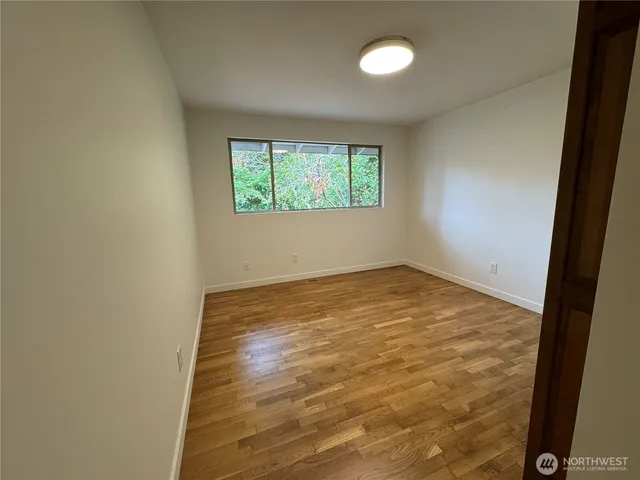 a bathroom with a granite countertop sink mirror and a toilet
