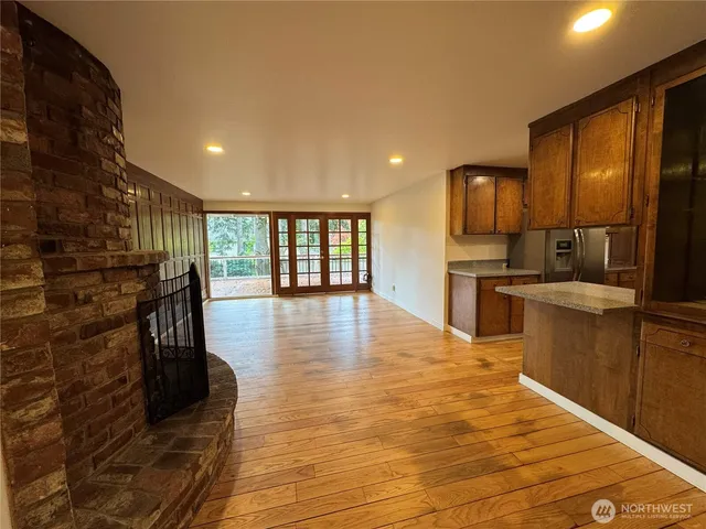 a view of a hallway with wooden floor and chandelier
