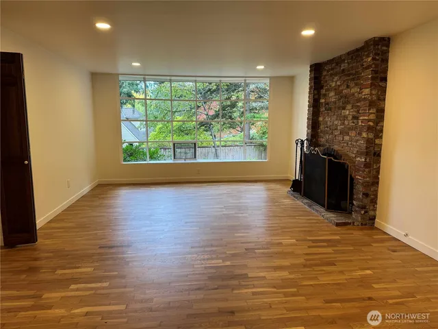 a kitchen with stainless steel appliances granite countertop a refrigerator a sink a stove a microwave a counter top and oven