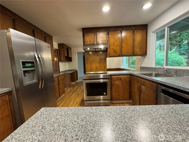 a view of a kitchen with wooden floor and a chandelier