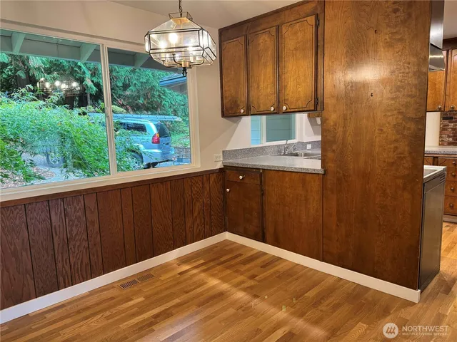a kitchen with a sink cabinets and appliances