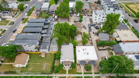 an aerial view of multiple houses with yard