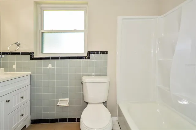 a bathroom with a toilet a sink and a window
