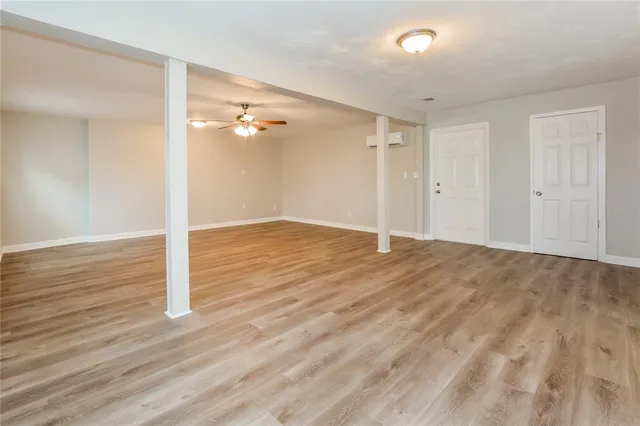 wooden floor in an empty room with a window