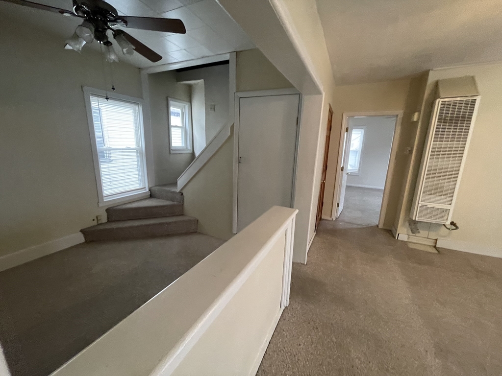 7 Buffum Street, Unit 2 Worcester, MA 01603 - Photo 5 of 23 a view of an empty room with stairs and a window
