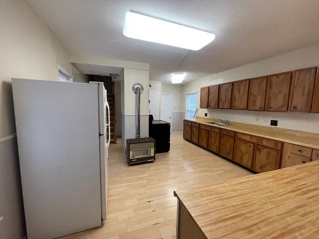 a kitchen with stainless steel appliances a refrigerator and a stove top oven