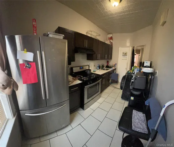 a kitchen with stainless steel appliances granite countertop a refrigerator stove and sink