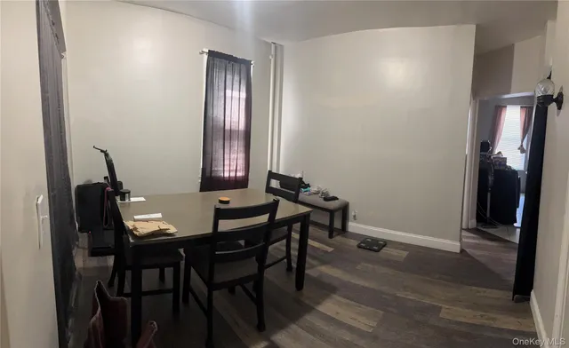 a view of a room with furniture and wooden floor