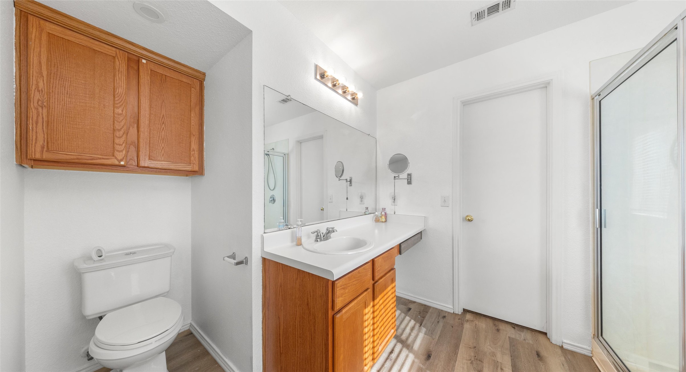 248 Endeavour Kyle, TX 78640 - Photo 14 of 32 Bathroom featuring vanity, a shower stall, and light wood-style floors