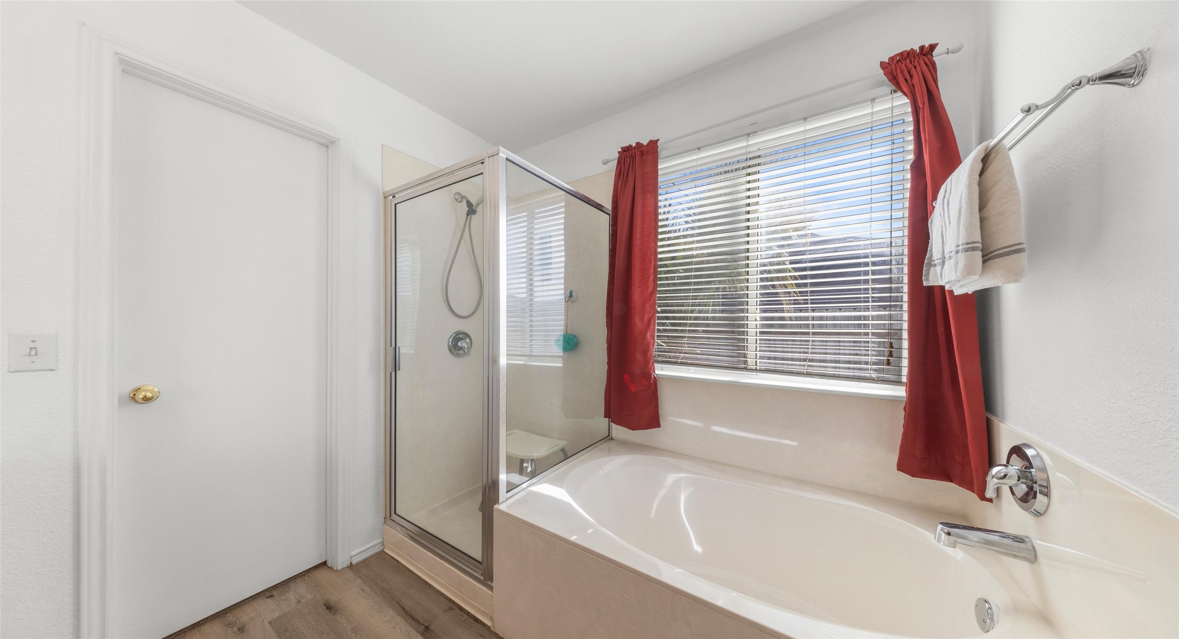 248 Endeavour Kyle, TX 78640 - Photo 15 of 32 Bathroom featuring a shower stall, a garden tub, and light wood-type flooring