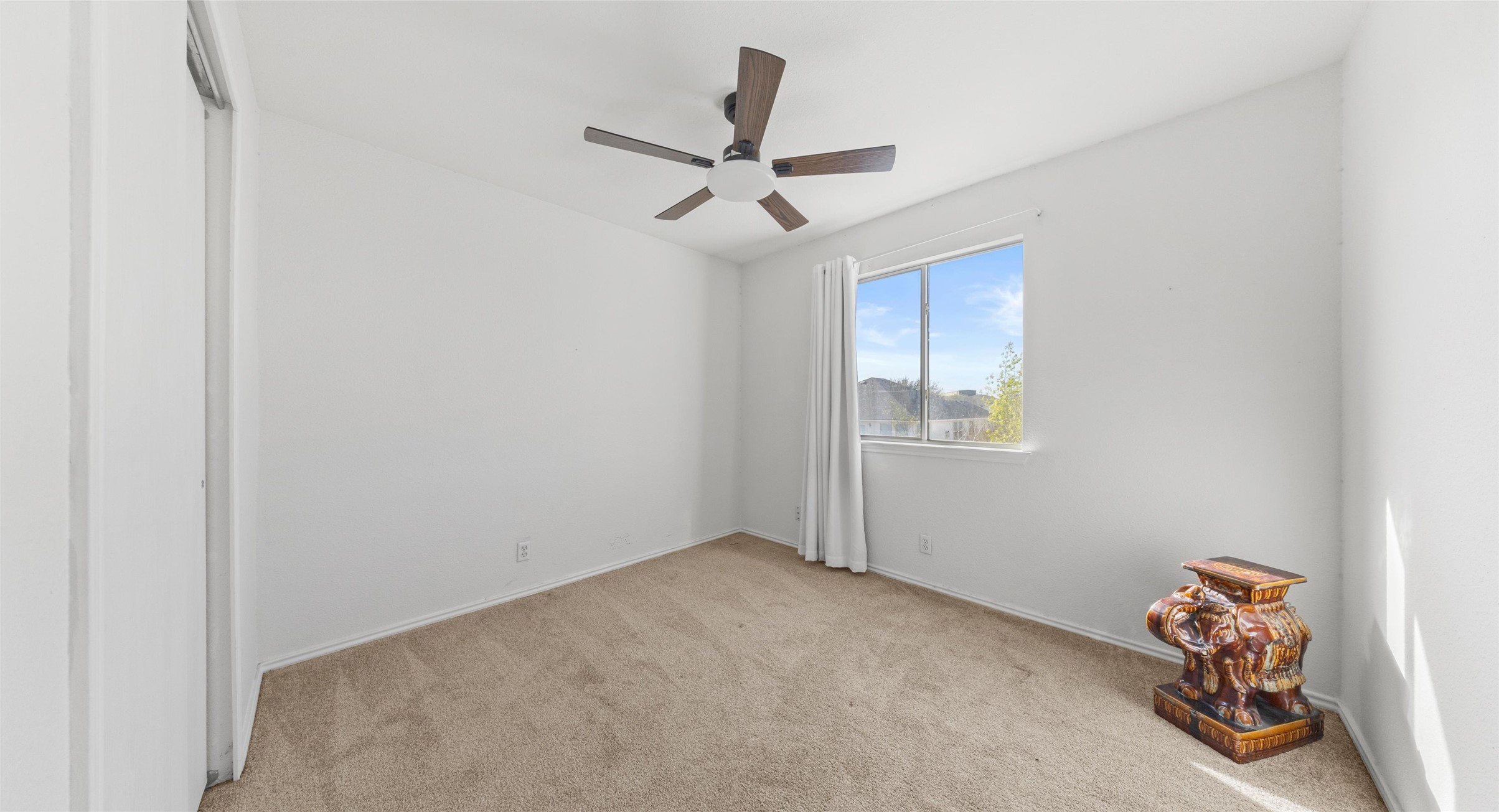 248 Endeavour Kyle, TX 78640 - Photo 18 of 32 Empty room featuring light colored carpet and a ceiling fan