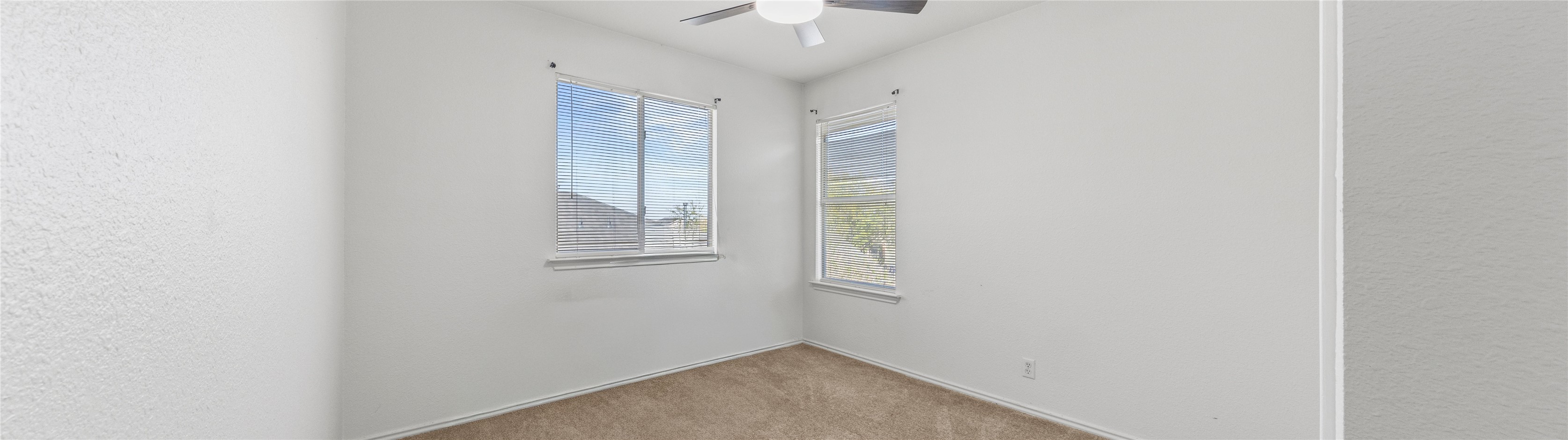 248 Endeavour Kyle, TX 78640 - Photo 19 of 32 Unfurnished room featuring light colored carpet, ceiling fan, and a textured wall