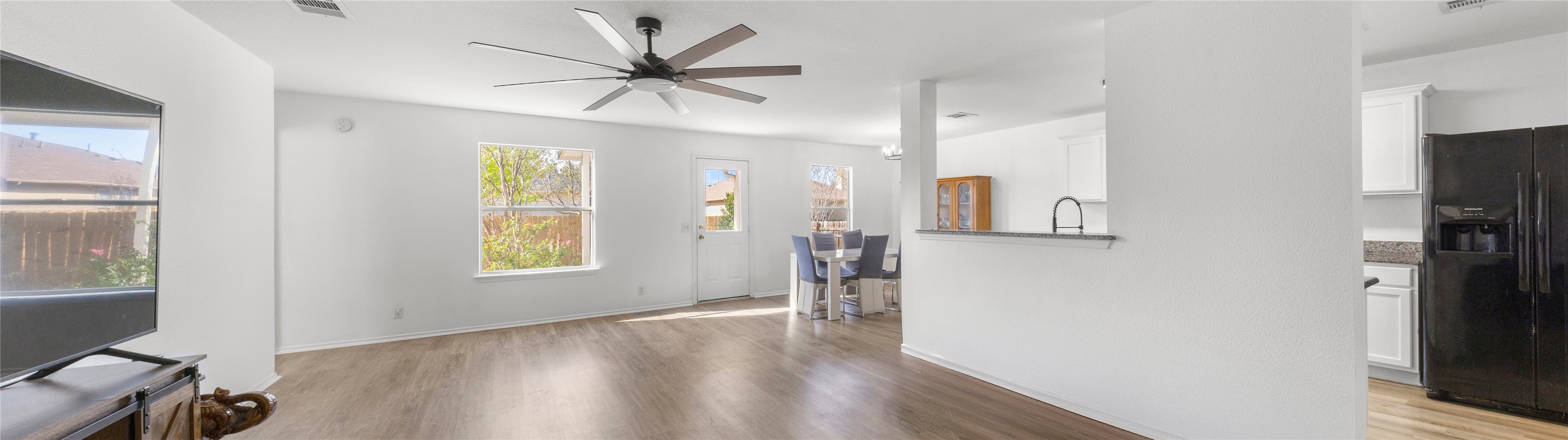 248 Endeavour Kyle, TX 78640 - Photo 3 of 32 Unfurnished living room featuring dark wood-style flooring and a ceiling fan