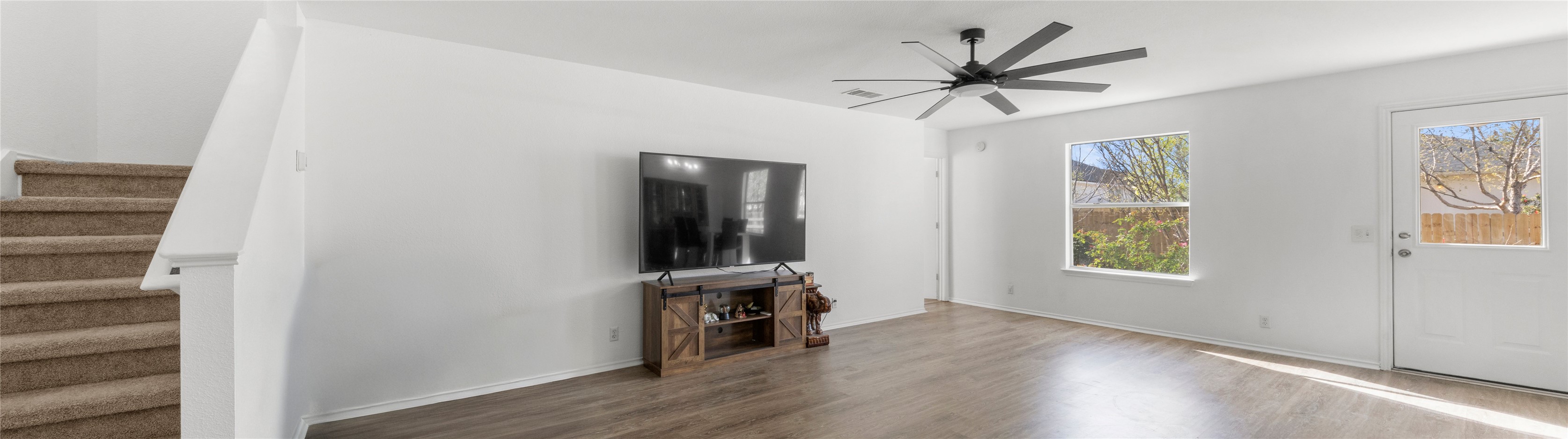 248 Endeavour Kyle, TX 78640 - Photo 4 of 32 Unfurnished living room with dark wood-type flooring and a ceiling fan