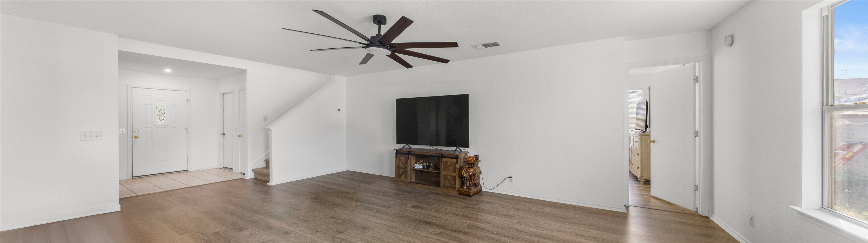 248 Endeavour Kyle, TX 78640 - Photo 5 of 32 Unfurnished living room with ceiling fan and dark wood-type flooring