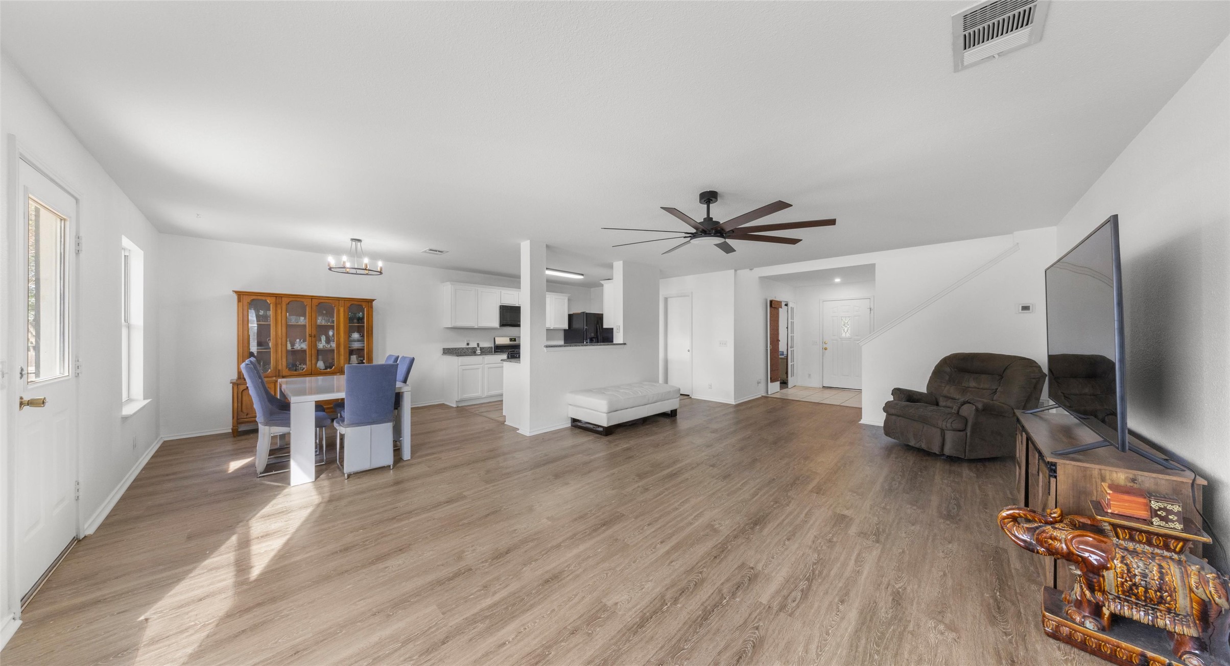 248 Endeavour Kyle, TX 78640 - Photo 6 of 32 Living area featuring light wood-style floors, ceiling fan, and suspended lighting