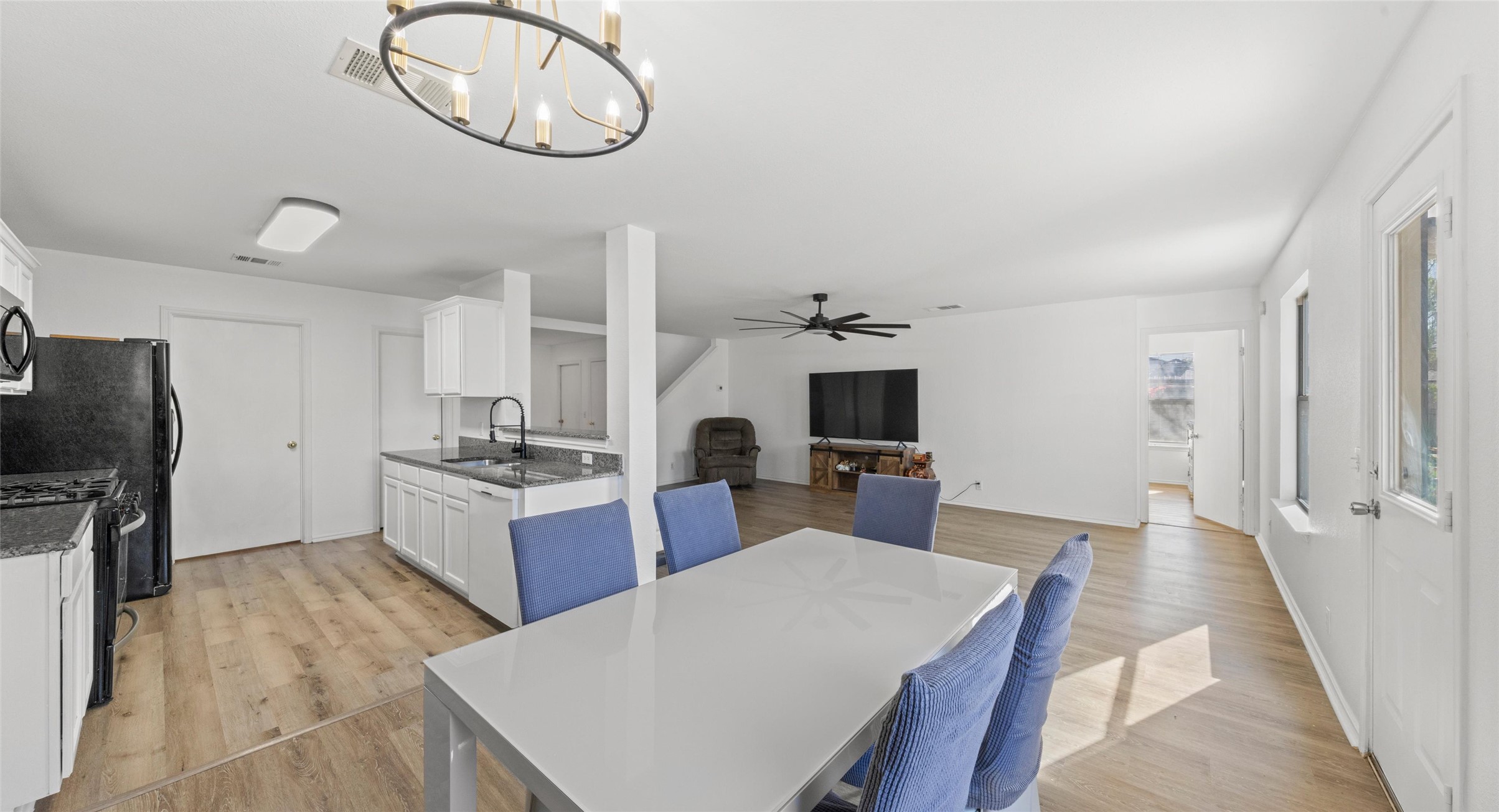 248 Endeavour Kyle, TX 78640 - Photo 9 of 32 Dining room with light wood-style floors, a chandelier, and ceiling fan