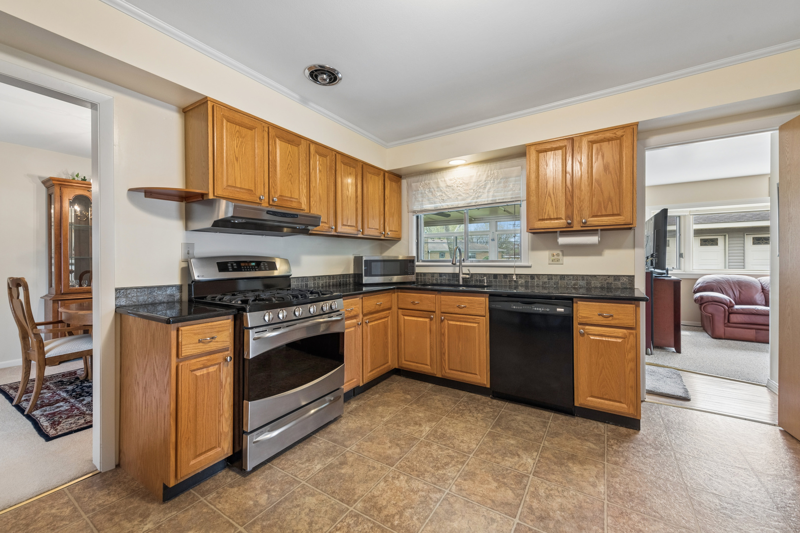 1715 Verde Court Mount Prospect, IL 60056 - Photo 10 of 30 a kitchen with stainless steel appliances granite countertop a stove sink and cabinets