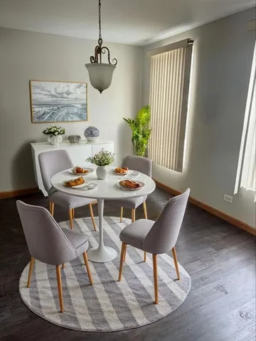 a dining room with furniture and window