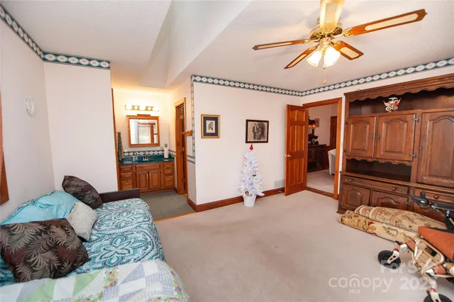 a bedroom with furniture and a chandelier