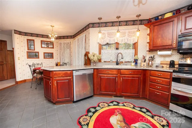 a kitchen with stainless steel appliances granite countertop a sink and cabinets