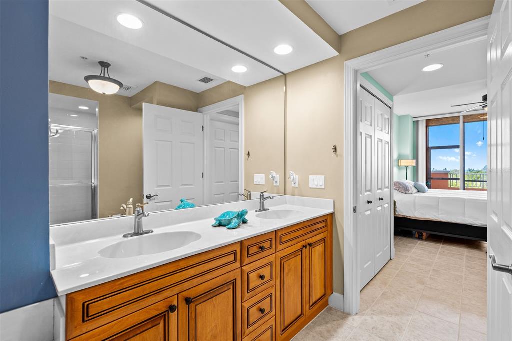 3191 Matecumbe Key Road, Unit 103 Punta Gorda, FL 33955 - Photo 20 of 48 a spacious bathroom with a granite countertop double vanity sink a mirror and a bathtub