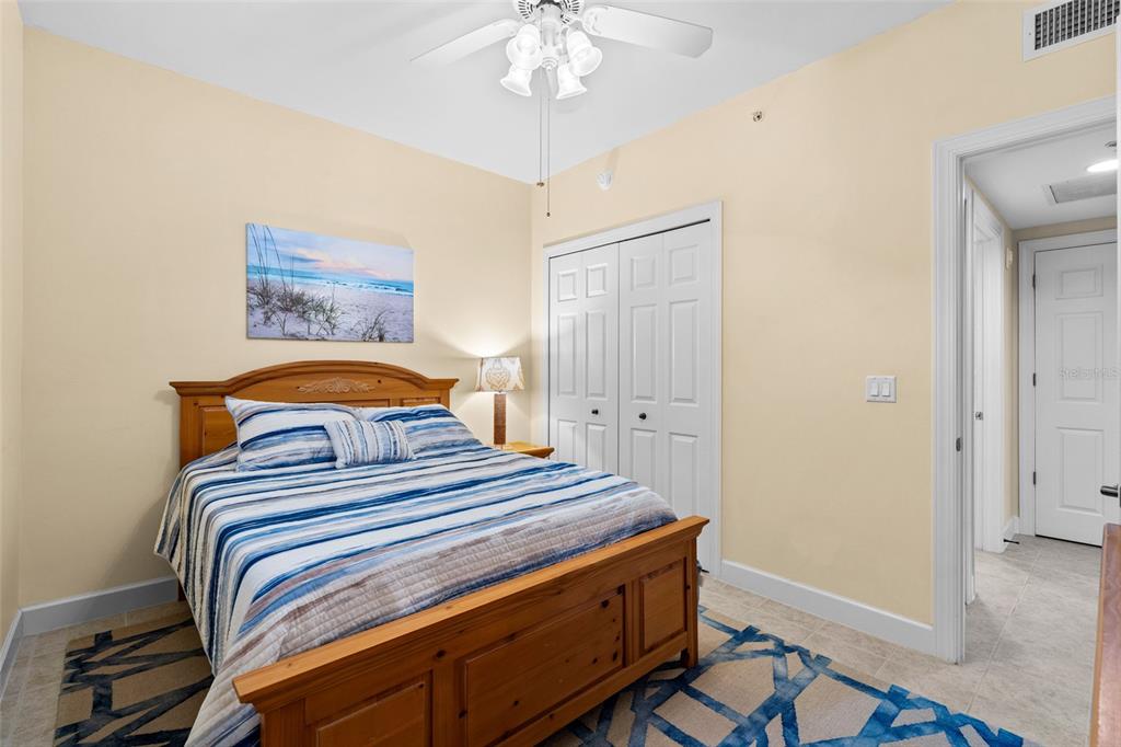 3191 Matecumbe Key Road, Unit 103 Punta Gorda, FL 33955 - Photo 22 of 48 a bedroom with a bed and a chandelier