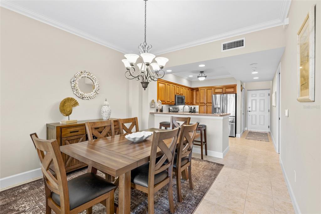 3191 Matecumbe Key Road, Unit 103 Punta Gorda, FL 33955 - Photo 8 of 48 a view of a dining room with furniture and chandelier